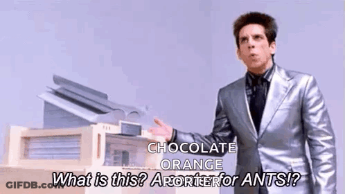Man In Silver Suit Talking About Chocolate Orange GIF