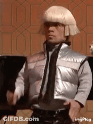 Man In Silver Vest And Blonde Wig GIF