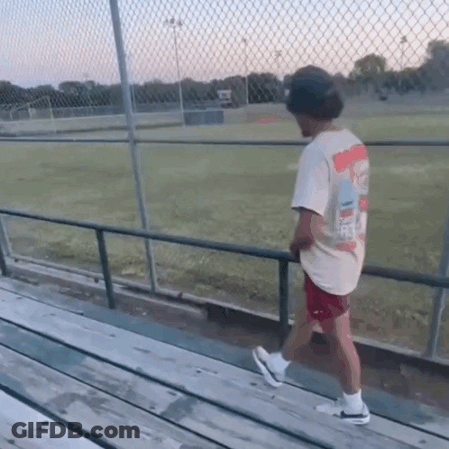 Man In Simpson T-Shirt Walking On Railing GIF