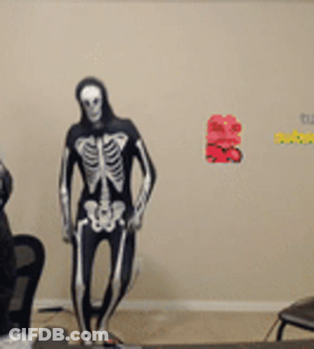 Man In Skeleton Costume Dancing In Front Of Computer GIF
