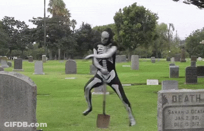 Man In Skeleton Costume Digging Cemetery GIF