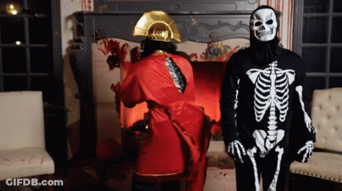 Man In Skeleton Costume Next To Man In Red Robe GIF