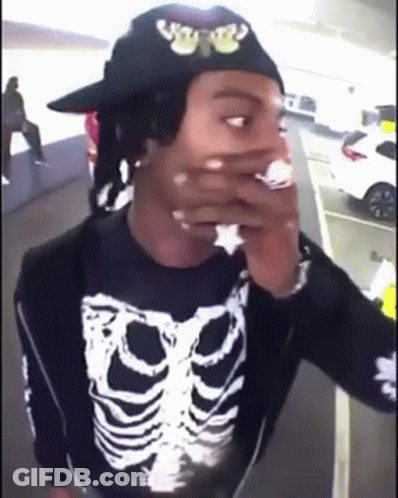 Man In Skeleton Shirt And Hat Smoking GIF