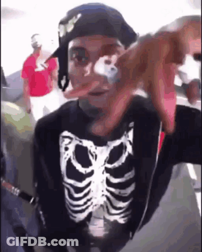 Man In Skeleton Shirt And Hat Taking Selfie On Plane GIF
