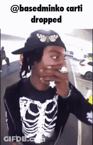 Man In Skeleton Shirt Smoking Cigarette Hat Saying @Basedminko Carti Dropped GIF