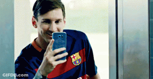Man In Ski Mask Holding Trophy With Coca Cola Kia Qatar Air Logos GIF