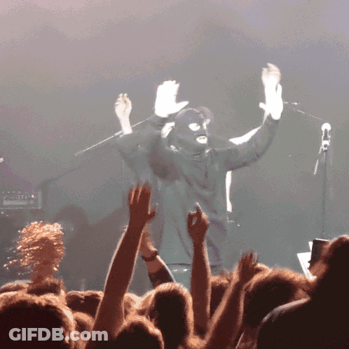 Man In Ski Mask In Front Of Crowd GIF