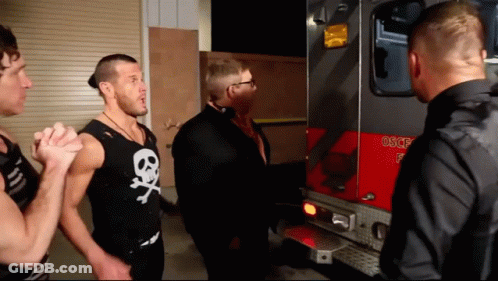 Man In Skull And Crossbones Tank Top In Front Of Fire Truck GIF