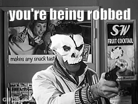 Man In Skull Mask Holding Gun By Refrigerator GIF