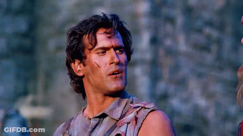 Man In Sleeveless Shirt Holding Gun GIF