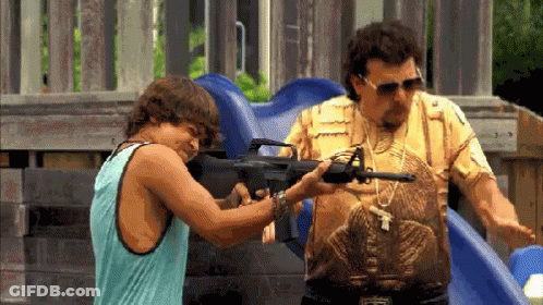Man In Snake Shirt Pointing Gun At Tank Top Man GIF
