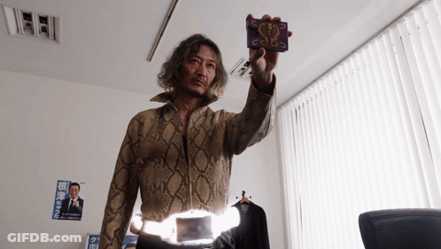Man In Snakeskin Jacket Holding Card With Snake GIF