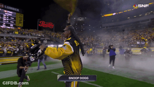 Man In Snoop Dogg Outfit Standing On Field GIF