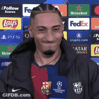Man In Soccer Uniform Smiling In Front Of FedEx Lays Heineken Ads GIF