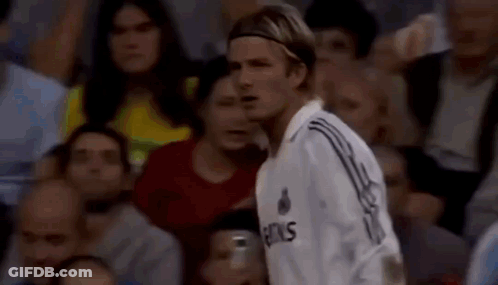 Man In Soccer Uniform Standing In Crowd GIF