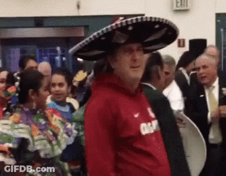 Man In Sombrero And Red Shirt In Front Of Crowd GIF