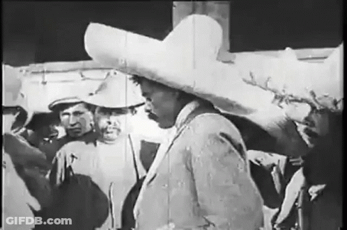 Man In Sombrero Standing In Front Of Group GIF
