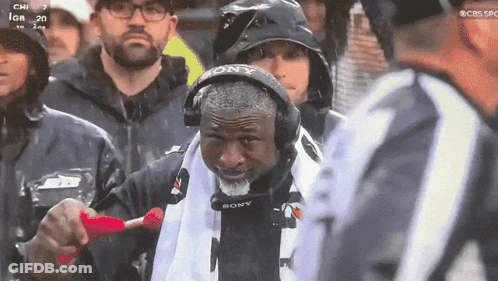 Man In Sony Headset Stands In Rain GIF
