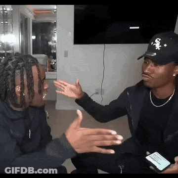 Man In Sox Hat Talking To Another Man GIF