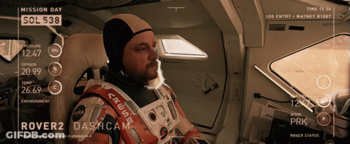 Man In Space Suit Looking At Mission Day Screen GIF