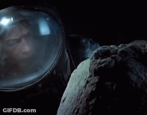 Man In Space Suit Looking Out Window GIF