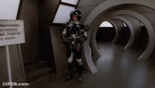 Man In Space Suit Near Authorized Tunnel Sign GIF