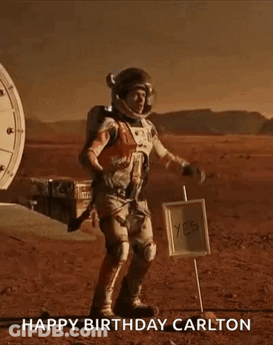 Man In Space Suit On Mars Next To Happy Birthday Carlton Sign GIF
