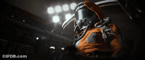 Man In Space Suit Standing In Dark Room With Lights GIF