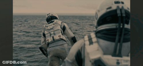 Man In Space Suit Walking Across Ocean GIF