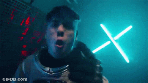 Man In Space Suit With Neon X In Dark Room GIF