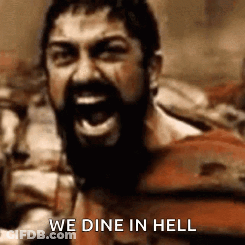 Man In Spartan Helmet Holding Shield And Sword GIF