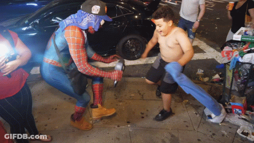Man In Spider-Man Costume Standing Next To Boy GIF