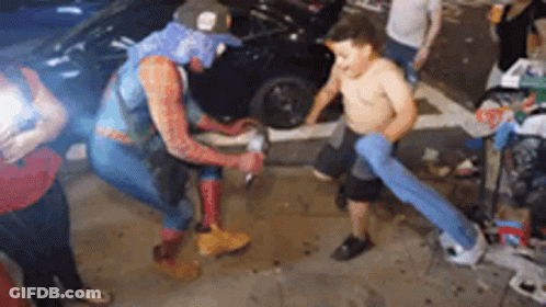 Man In Spiderman Costume Beside Shirtless Boy GIF