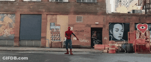 Man In Spiderman Costume With Graffiti Building GIF