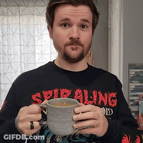 Man In Spiraling Shirt Holding Coffee GIF