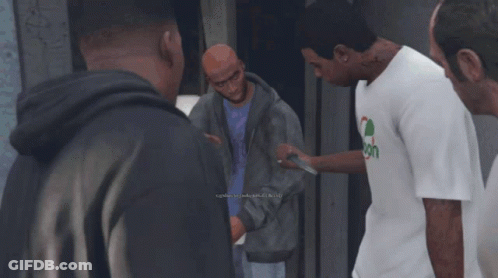 Man In Spoon Shirt Talks To Group Of Men GIF