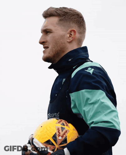 Man In Sports Jacket Holding Ball GIF