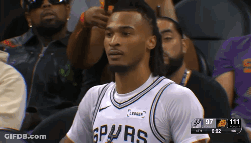 Man In Spurs Jersey Sitting In Stands GIF