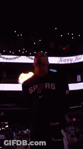 Man In Spurs Shirt In Front Of Flames GIF