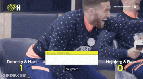 Man In Spurs Sweater Laughing With Coffee GIF