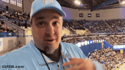 Man In Stadium With Titans On Wall GIF