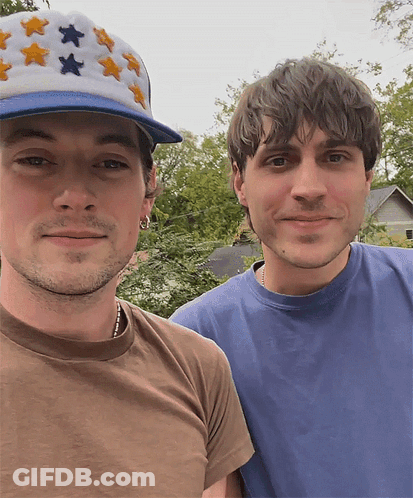 Man In Star Hat Next To Man In Blue Shirt GIF