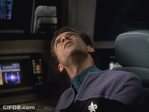 Man In Star Trek Uniform Lying Down GIF