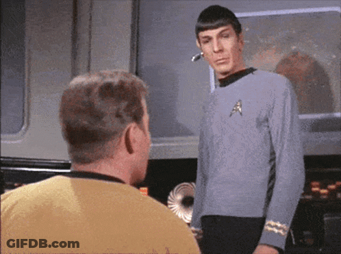Man In Star Trek Uniform Talking To Man In Yellow Shirt GIF