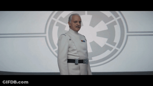 Man In Star Wars Uniform In Front Of Logo GIF