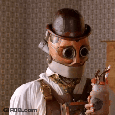 Man In Steampunk Helmet And Goggles Holding Milkshake GIF