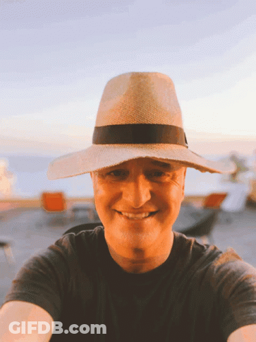 Man In Straw Hat And Black Shirt Smiling GIF