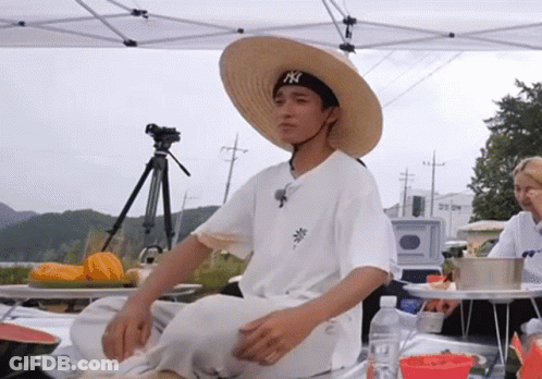 Man In Straw Hat And NY Hat Sitting GIF