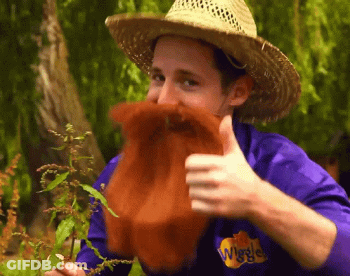 Man In Straw Hat And Purple Shirt Wiggles GIF
