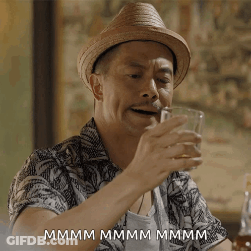 Man In Straw Hat Drinking Glass Saying Mmm GIF